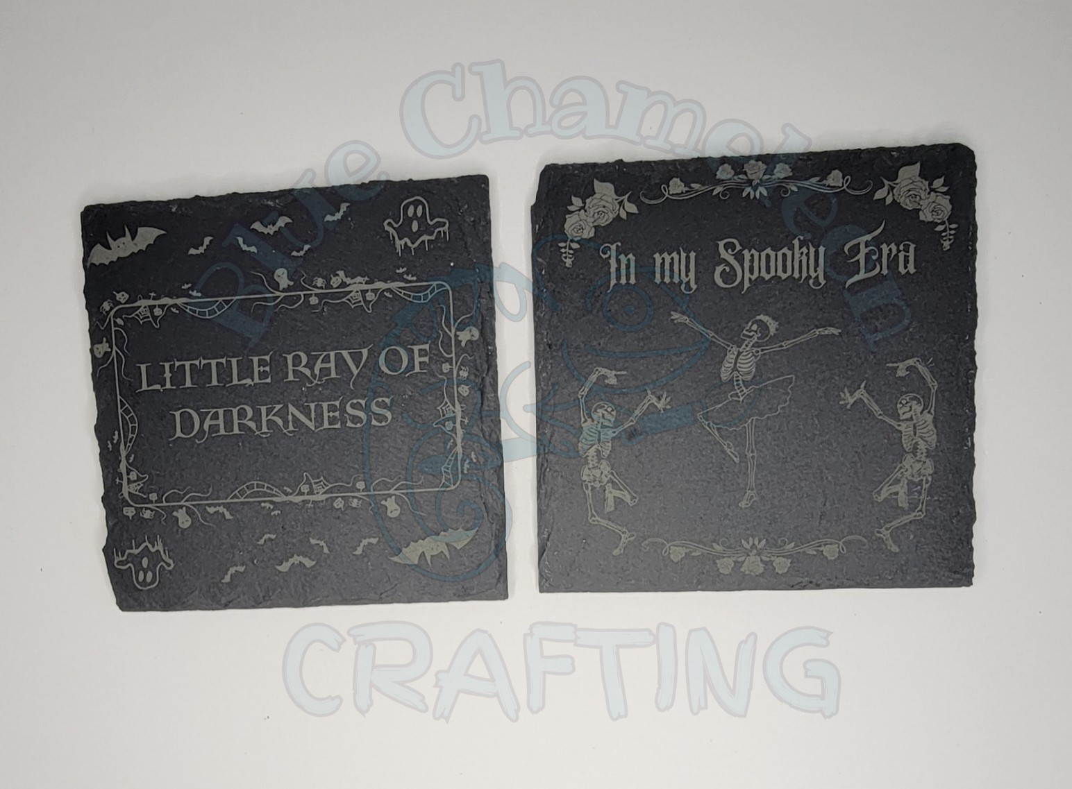 Custom laser engraved stone coaster with spooky design on tabletop.